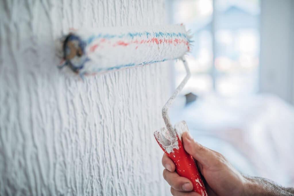 painting wall with paint roller